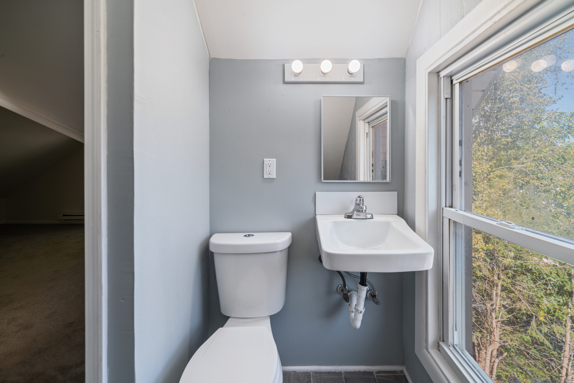 23 Salem Street Naugatuck, CT 06770 - Photo 24 of 40 a bathroom with a sink a mirror and a toilet