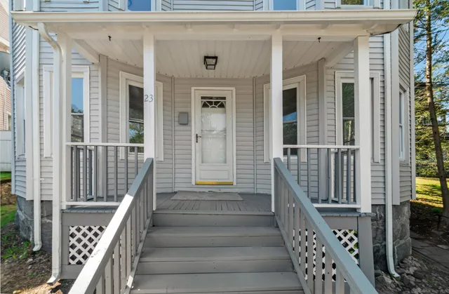 a view of a balcony with wooden floor and fence