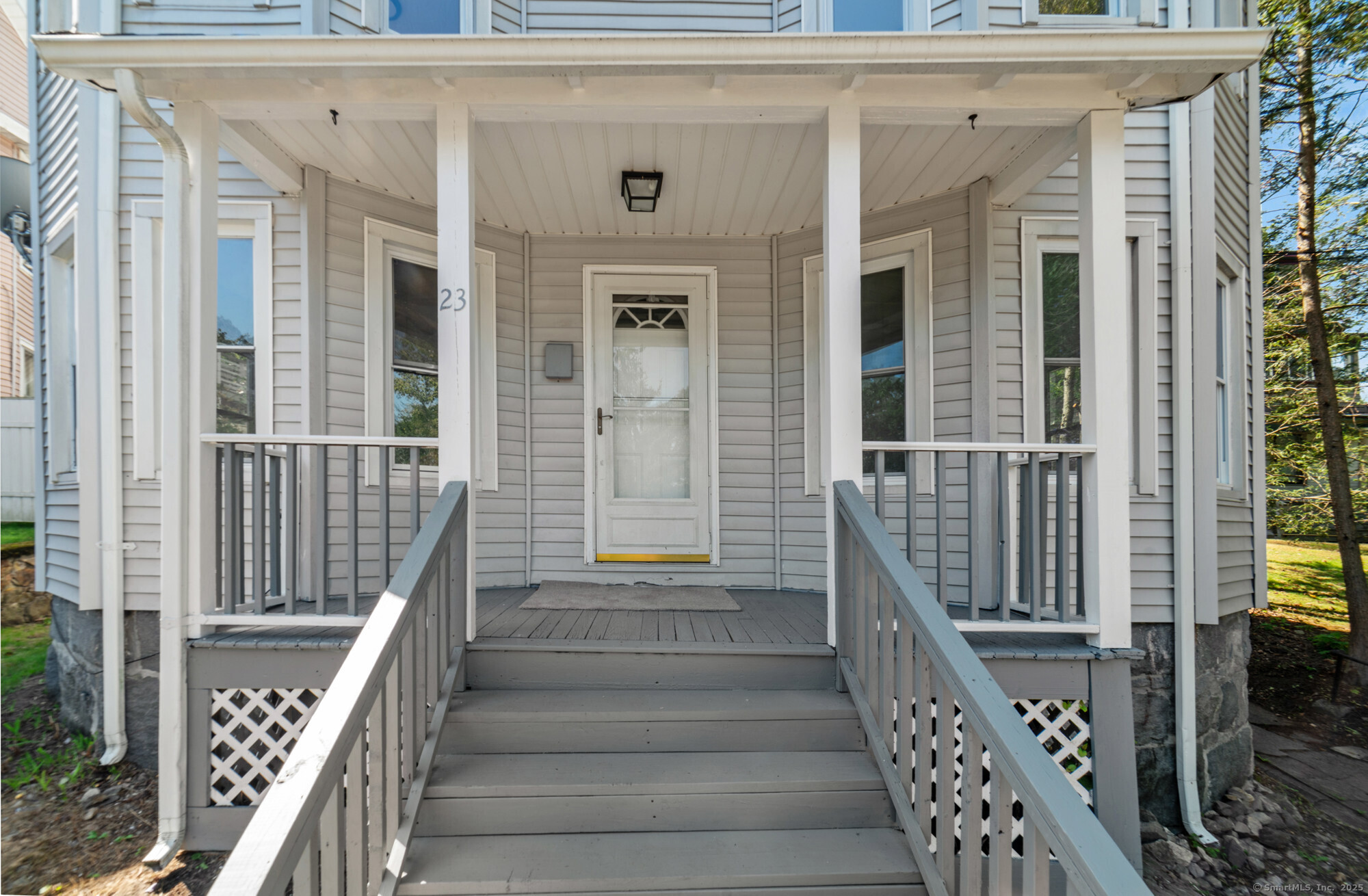 23 Salem Street Naugatuck, CT 06770 - Photo 4 of 40 a view of a balcony with wooden floor and fence