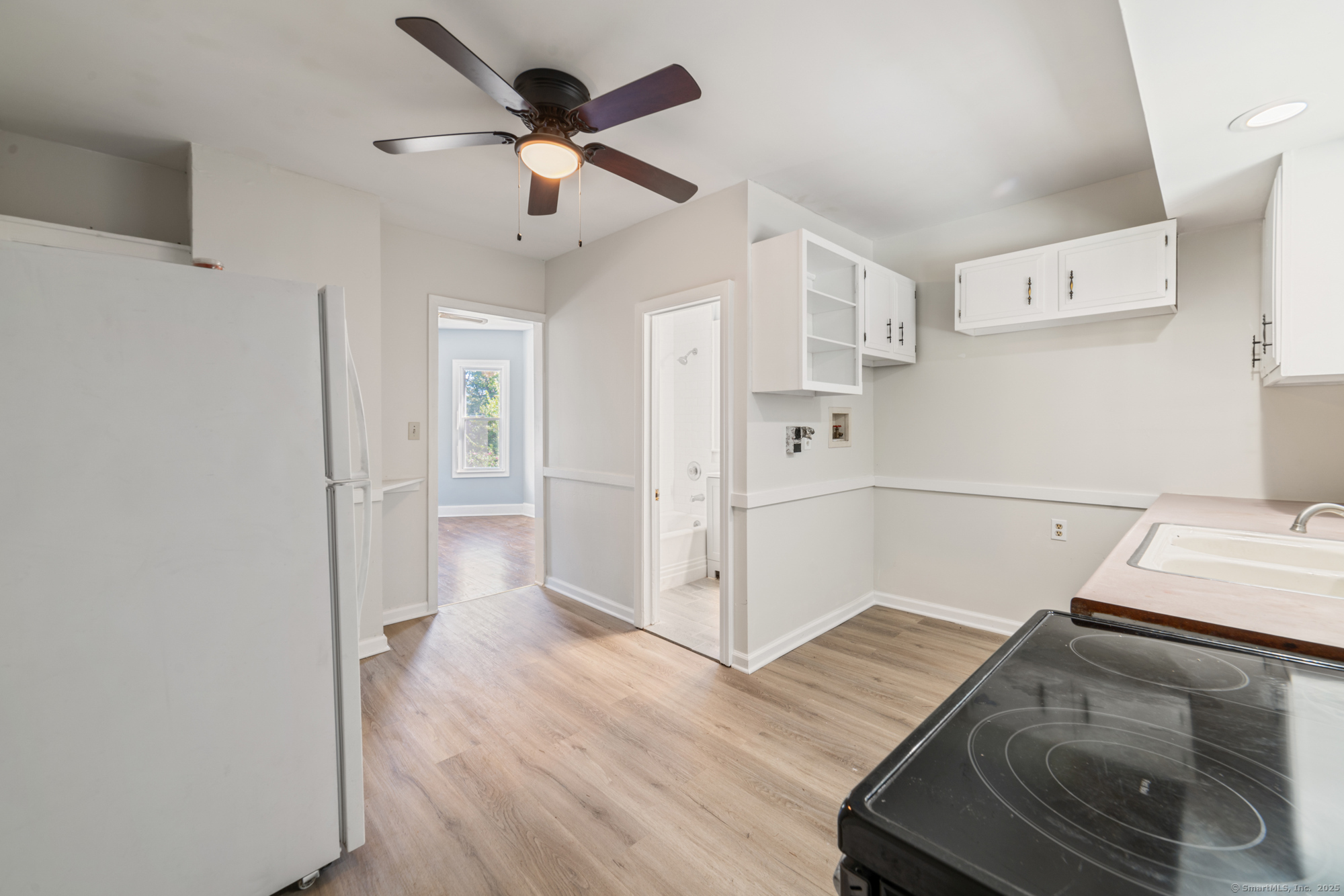 23 Salem Street Naugatuck, CT 06770 - Photo 5 of 40 a view of a kitchen with wooden floor and a ceiling fan