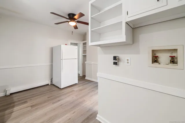 a view of cabinets and wooden floor in a kitchen