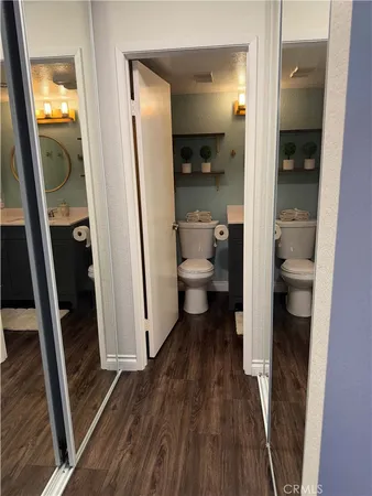a bathroom with a toilet sink and mirror