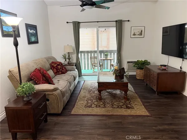 a living room with furniture a rug and a flat screen tv