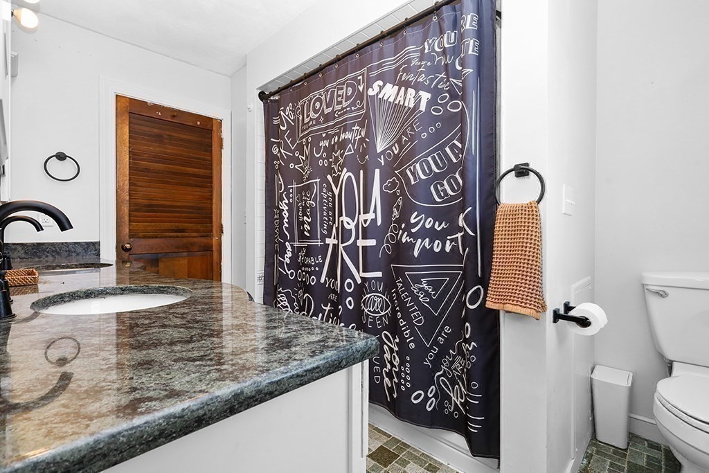 163 Walnut Road Wrentham, MA 02093 - Photo 13 of 39 a bathroom with a granite countertop sink a toilet and shower