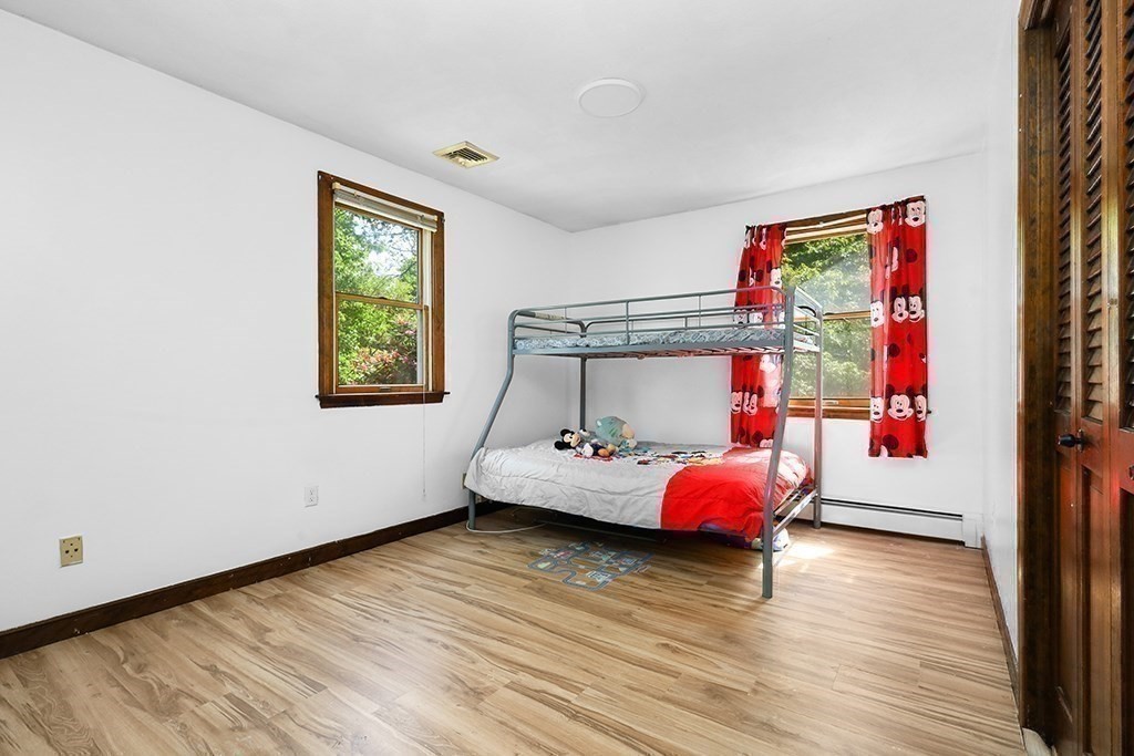 163 Walnut Road Wrentham, MA 02093 - Photo 17 of 39 a bedroom with a bed and wooden floor