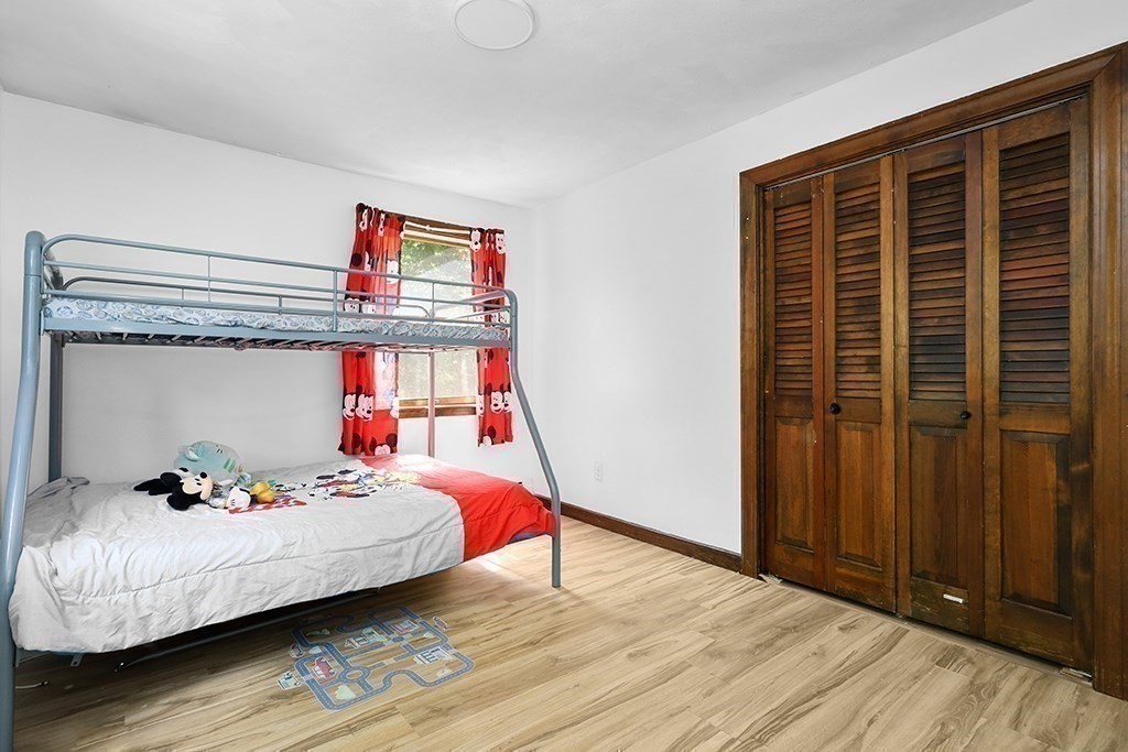 163 Walnut Road Wrentham, MA 02093 - Photo 18 of 39 a bedroom with a bed and wooden floor