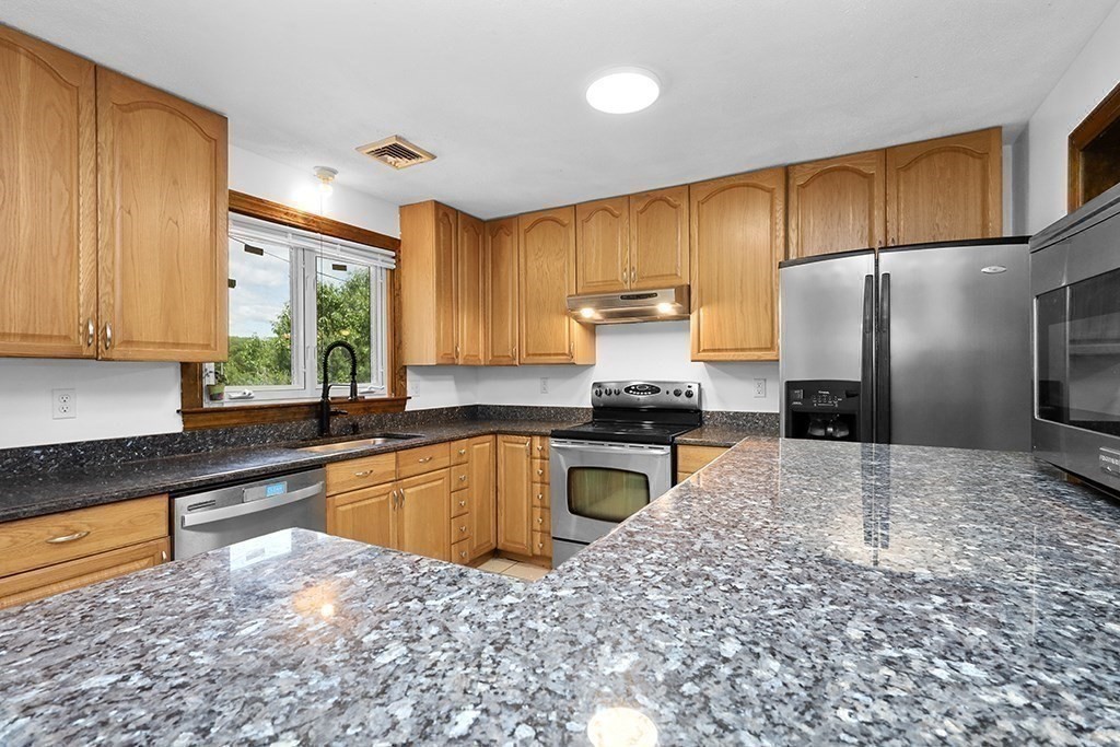 163 Walnut Road Wrentham, MA 02093 - Photo 4 of 39 a kitchen with a refrigerator sink and cabinets