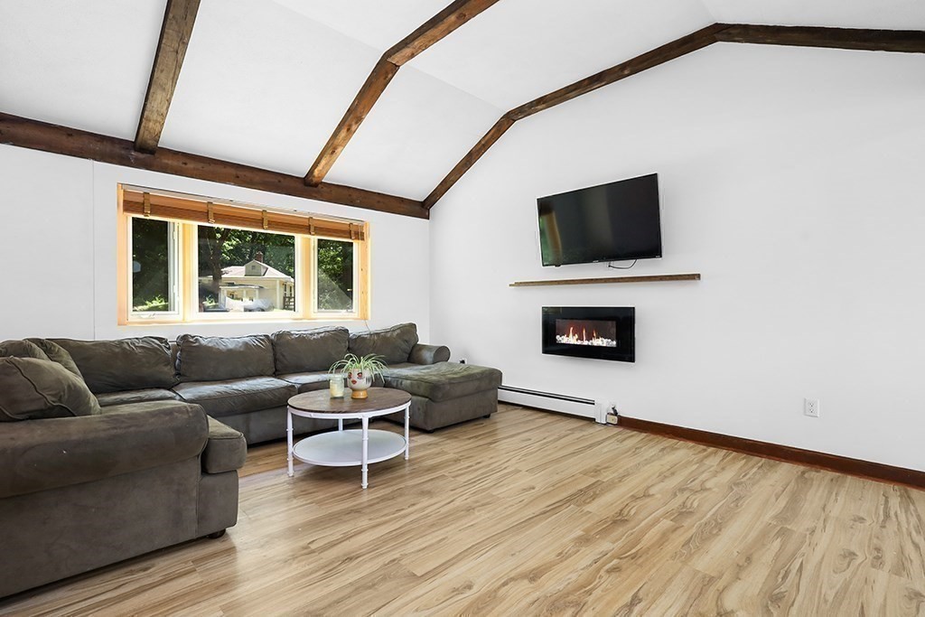 163 Walnut Road Wrentham, MA 02093 - Photo 9 of 39 a living room with furniture and a flat screen tv