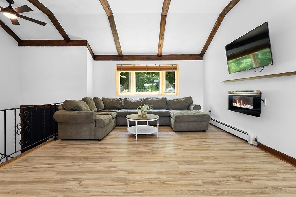163 Walnut Road Wrentham, MA 02093 - Photo 10 of 39 a living room with furniture tv and a window