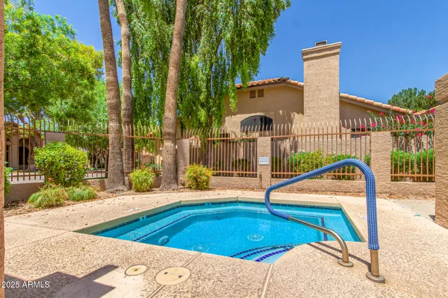 a view of a swimming pool with a patio and a yard