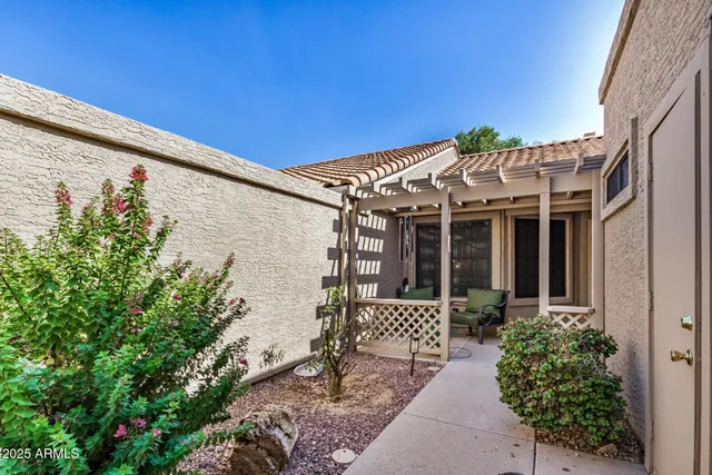 a view of a house with a small yard and a garden