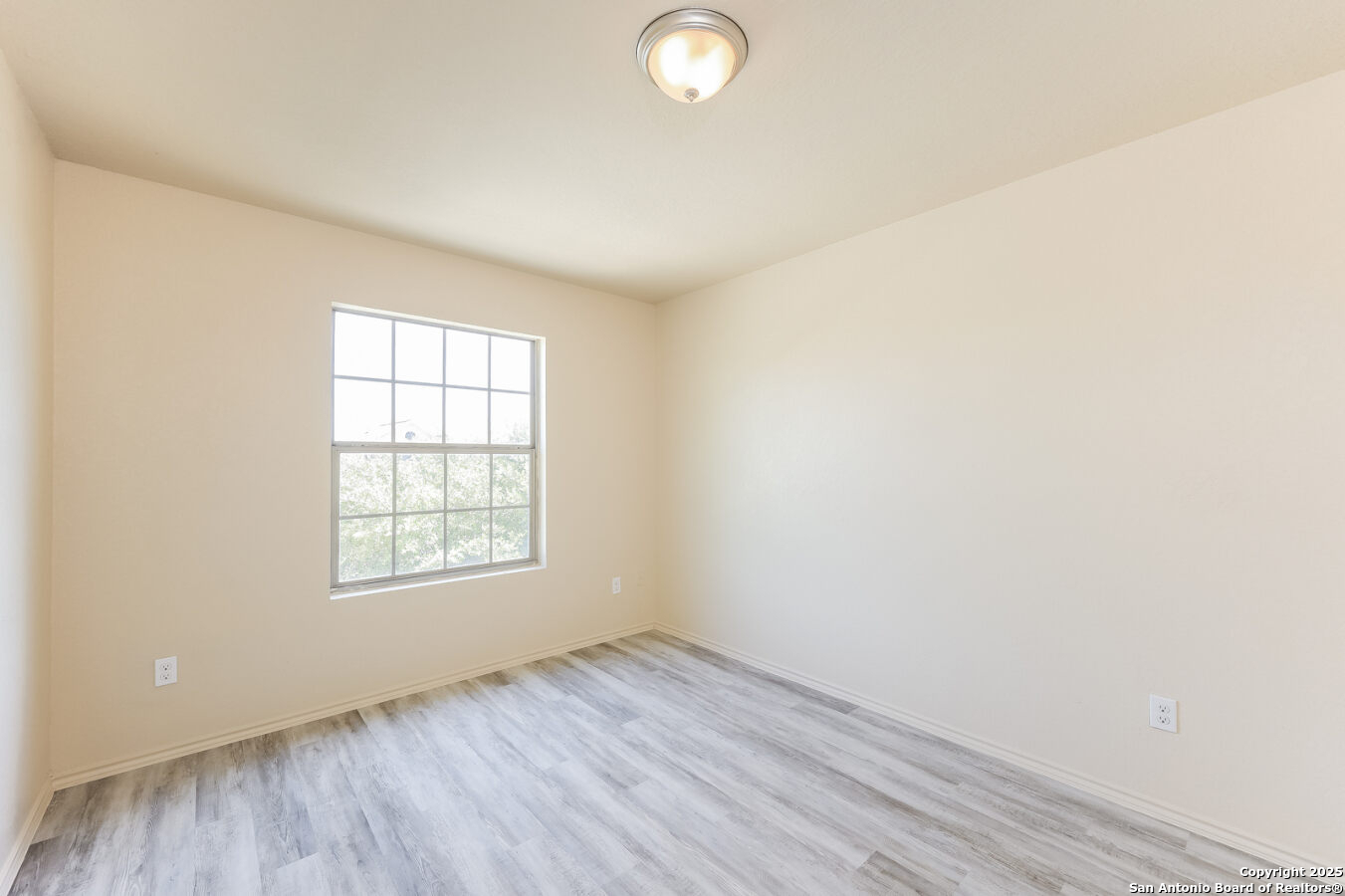 1415 Durango Run San Antonio, TX 78245 - Photo 11 of 14 an empty room with wooden floor and windows
