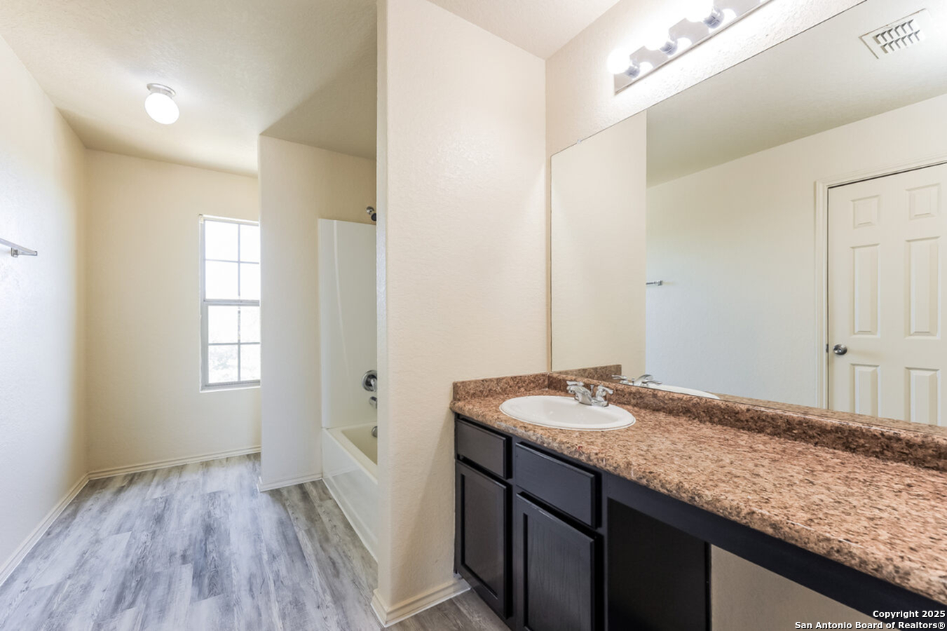 1415 Durango Run San Antonio, TX 78245 - Photo 12 of 14 a bathroom with a granite countertop sink and a mirror