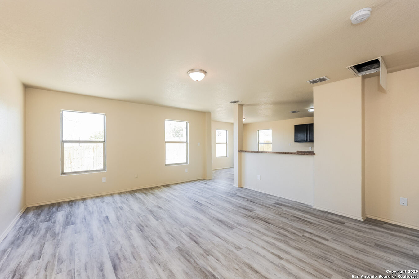 1415 Durango Run San Antonio, TX 78245 - Photo 6 of 14 an empty room with wooden floor and windows