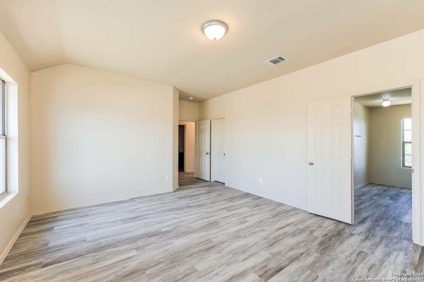 1415 Durango Run San Antonio, TX 78245 - Photo 7 of 14 an empty room with wooden floor and windows