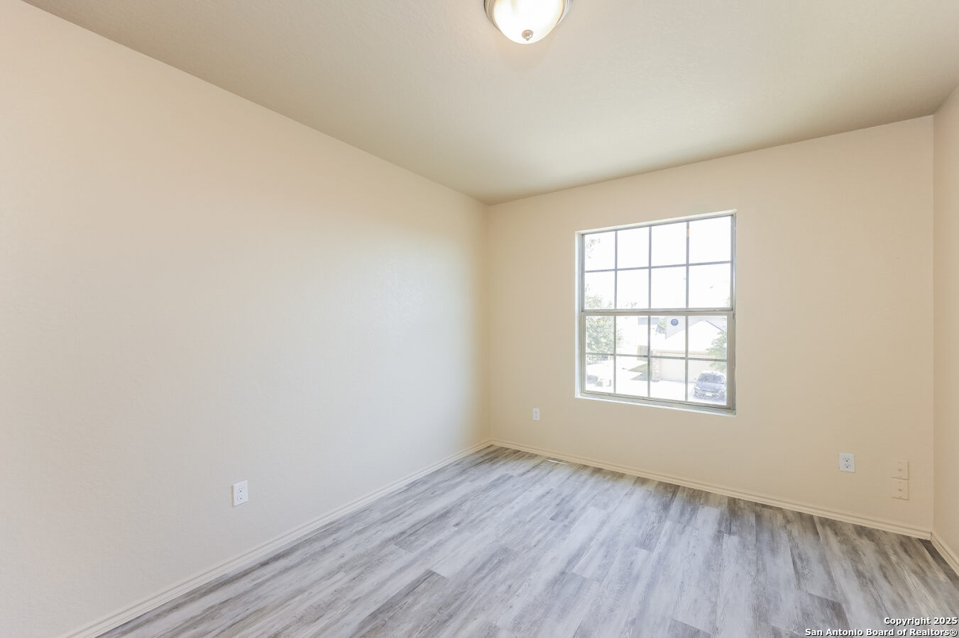 1415 Durango Run San Antonio, TX 78245 - Photo 8 of 14 an empty room with wooden floor and windows