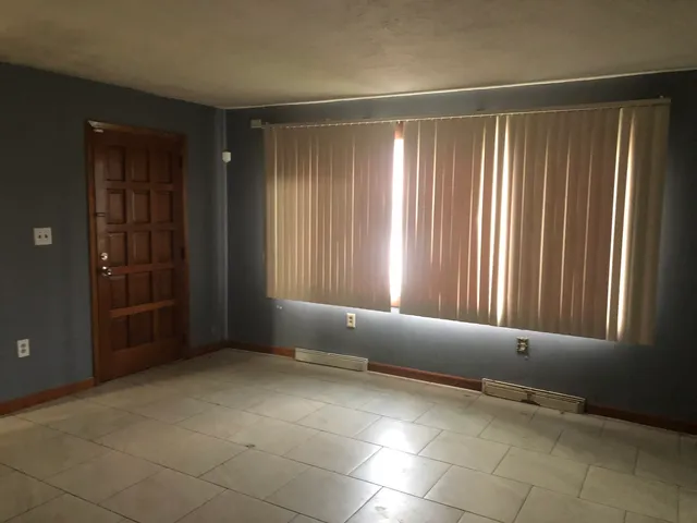 a view of an empty room and window
