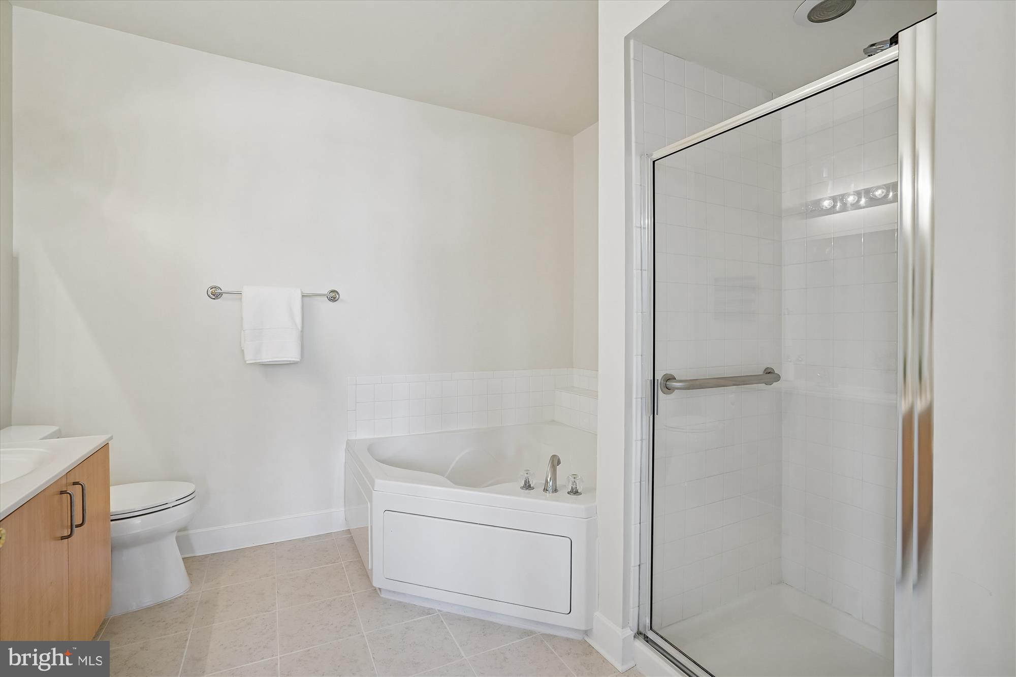 1851 Stratford Park Place, Unit 304 Reston, VA 20190 - Photo 16 of 38 Primary bath has new ceramic tile floor.