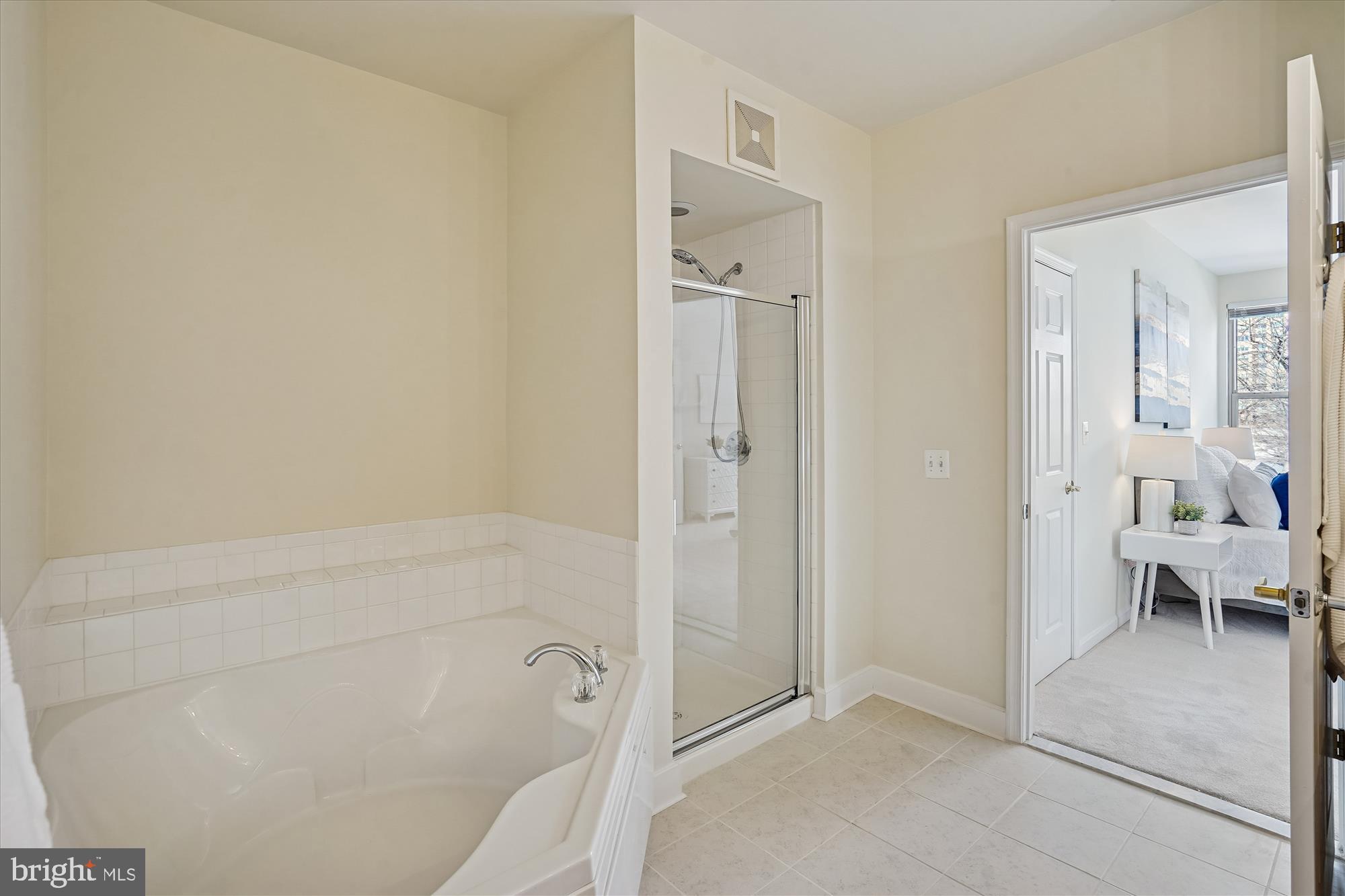 1851 Stratford Park Place, Unit 304 Reston, VA 20190 - Photo 17 of 38 Soaking tub and separate shower in primary bath.