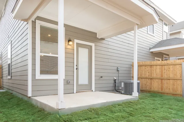 a view of a house with a yard patio and fire pit