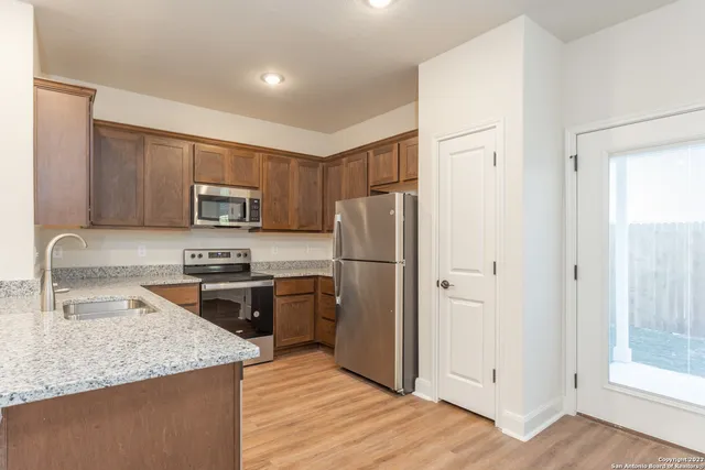 a kitchen with a refrigerator stove and sink