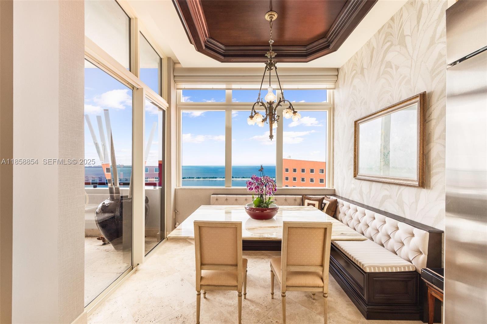 1581 Brickell Avenue, Unit T104 Miami, FL 33129 - Photo 14 of 42 a dining room with furniture and a chandelier