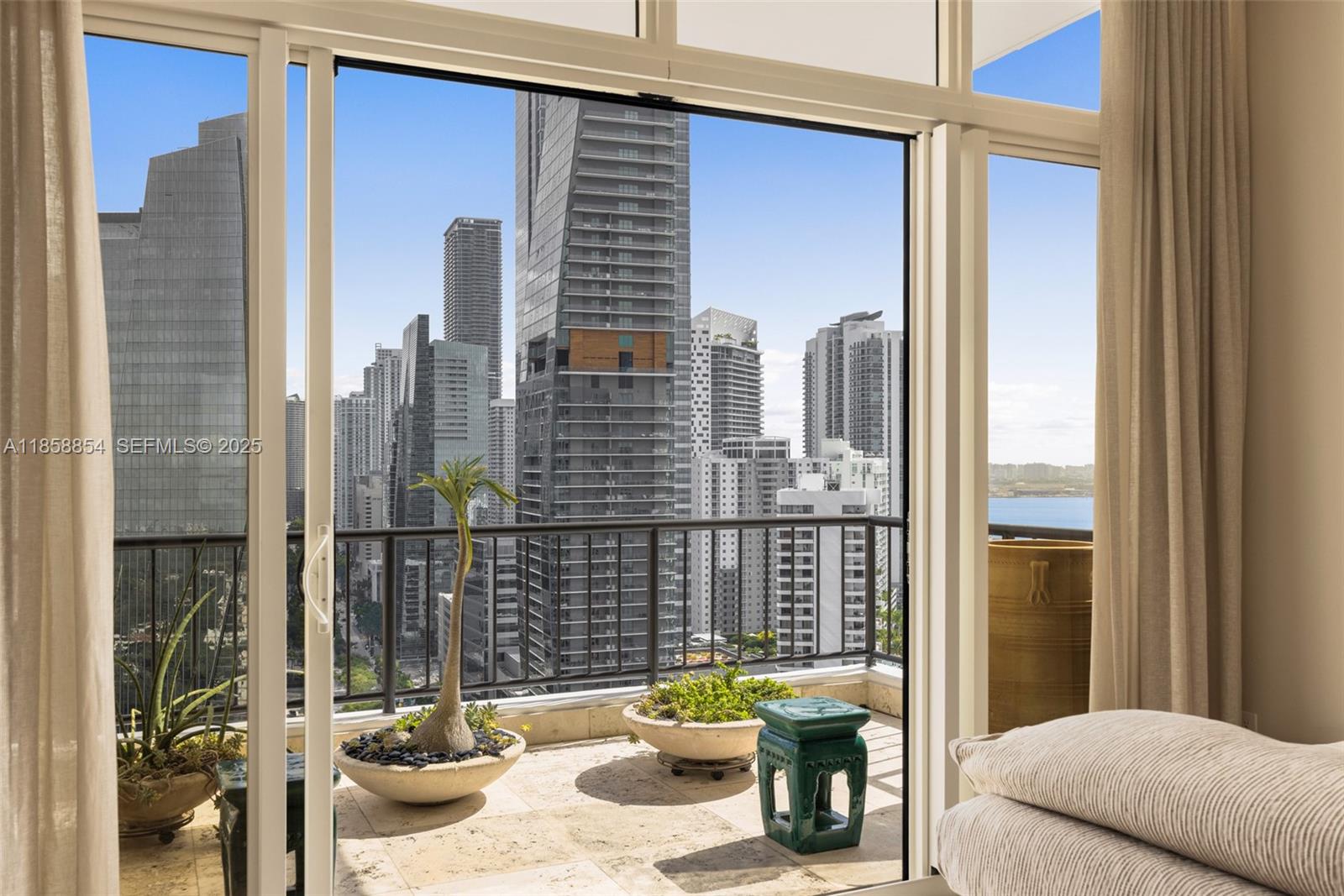 1581 Brickell Avenue, Unit T104 Miami, FL 33129 - Photo 17 of 42 a view of a balcony with dining table and chairs