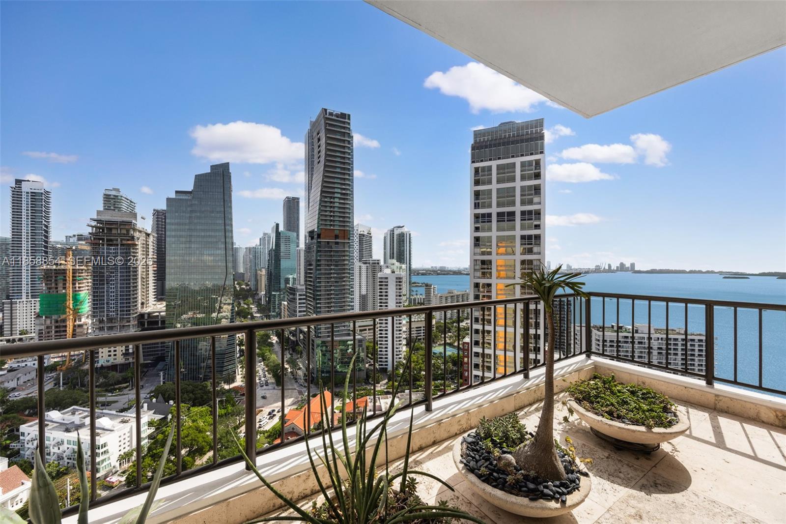 1581 Brickell Avenue, Unit T104 Miami, FL 33129 - Photo 18 of 42 a view of a balcony with two chairs and a potted plant