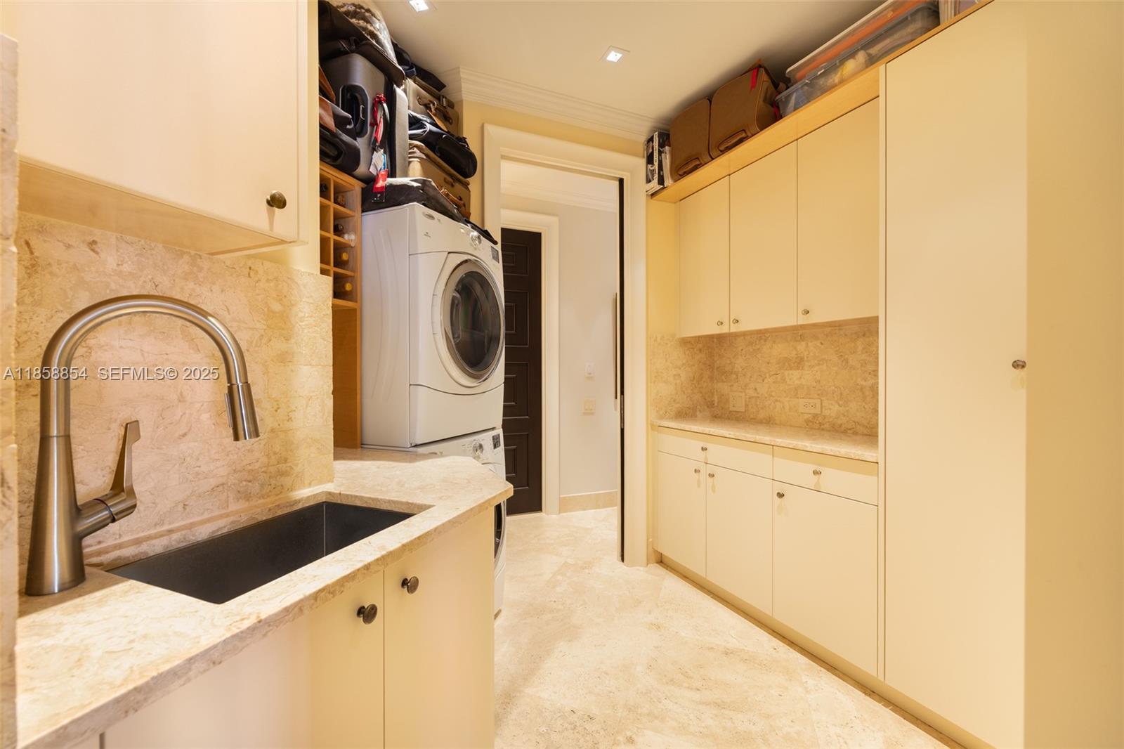 1581 Brickell Avenue, Unit T104 Miami, FL 33129 - Photo 25 of 42 a close view of a sink a faucet and a refrigerator