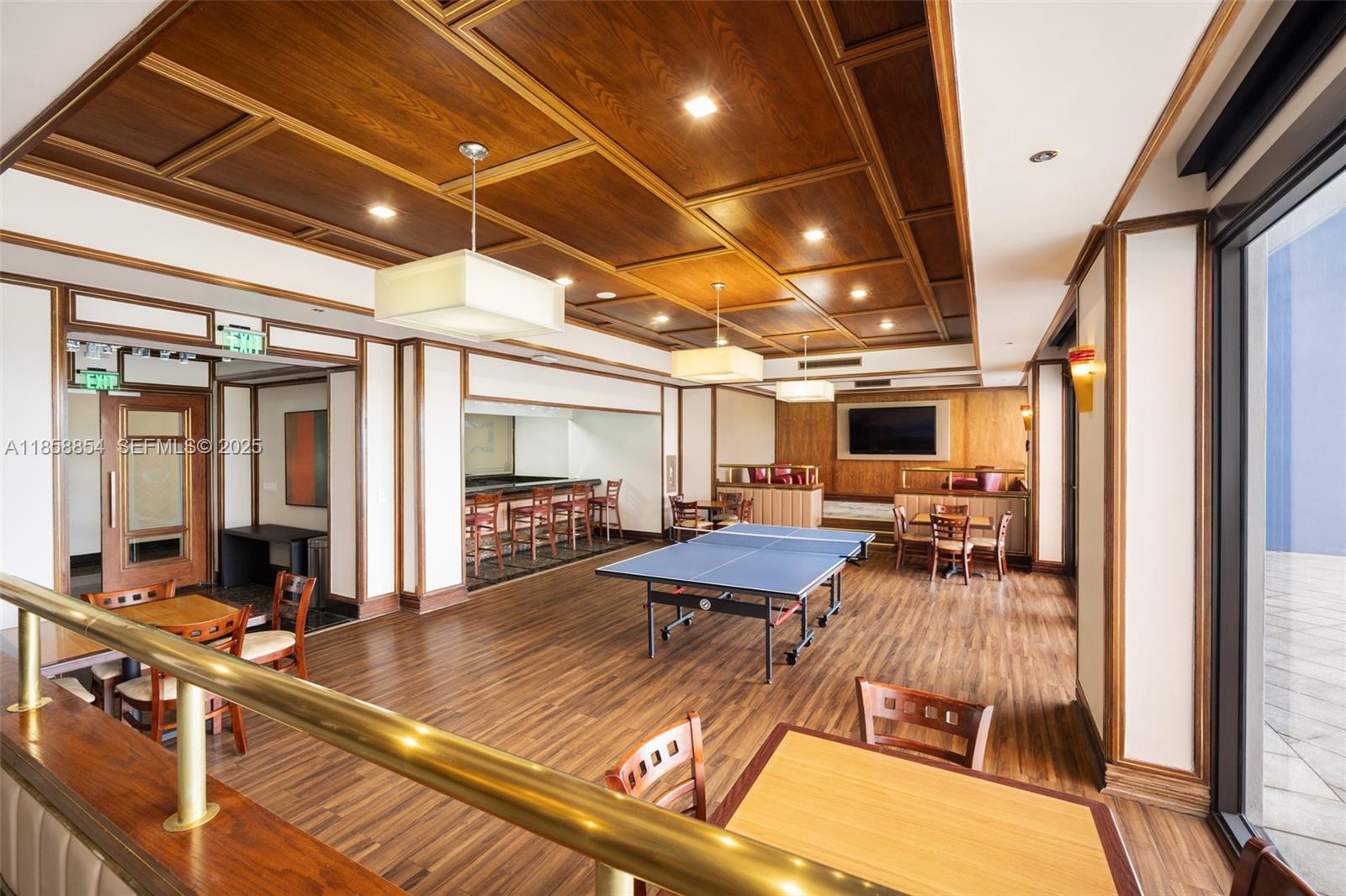 1581 Brickell Avenue, Unit T104 Miami, FL 33129 - Photo 27 of 42 a view of a patio with table and chairs with wooden floor