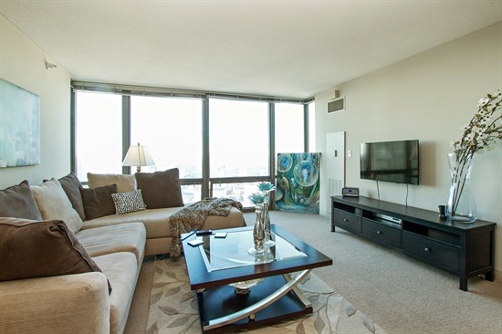 2 East Erie Street, Unit 3906 Chicago, IL 60611 - Photo 3 of 13 a living room with furniture and a flat screen tv