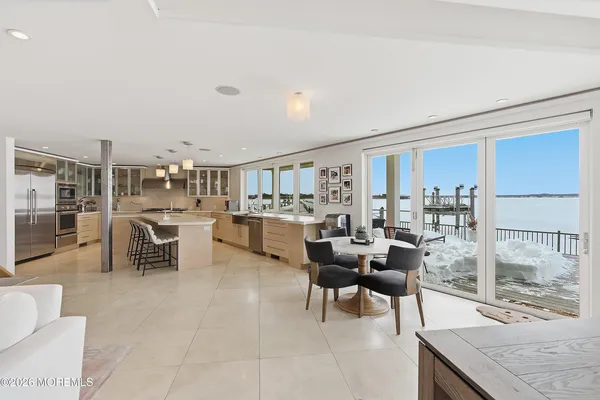 a living room with lots of furniture and view of kitchen