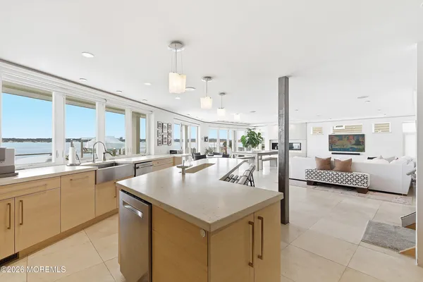 a kitchen with a stove a counter space a sink and cabinets