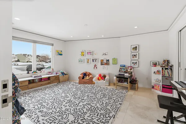 a bedroom with furniture and a book shelf