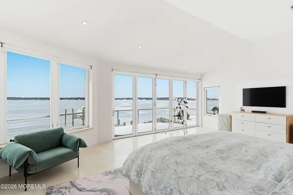 a bedroom with furniture and a flat screen tv