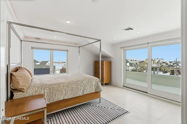 a bedroom with a bed and large window