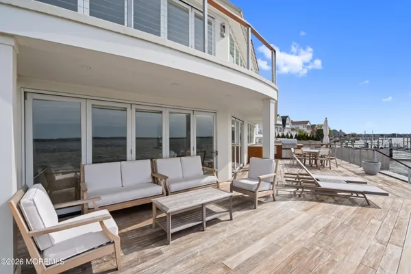 a view of a roof deck with couches and sky view