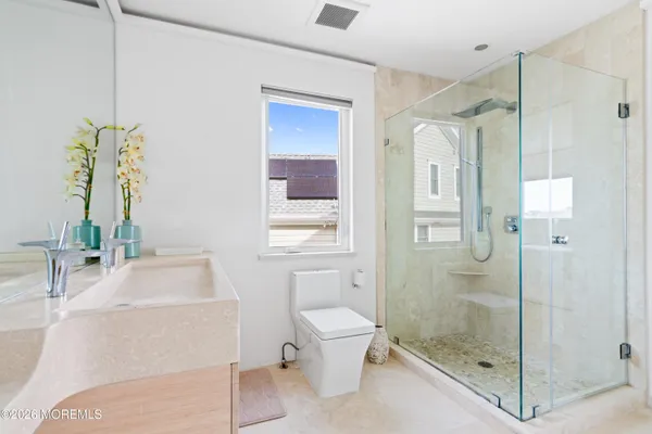 a bathroom with a sink toilet and shower