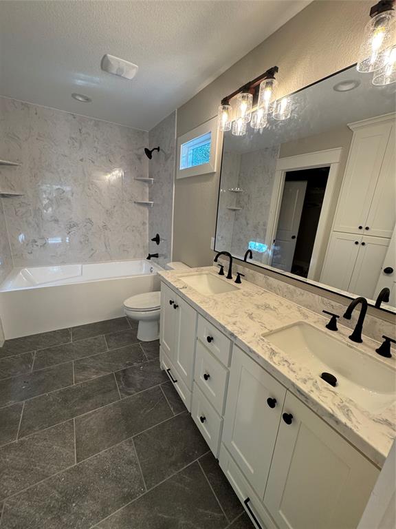 2340 Ft Graham Road Elm Mott, TX 76640 - Photo 16 of 24 a bathroom with a double vanity sink toilet mirror and bathtub