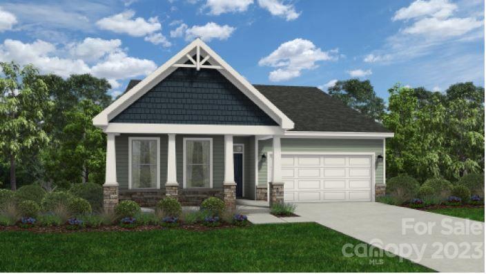 a view of a house with brick walls and a yard with plants