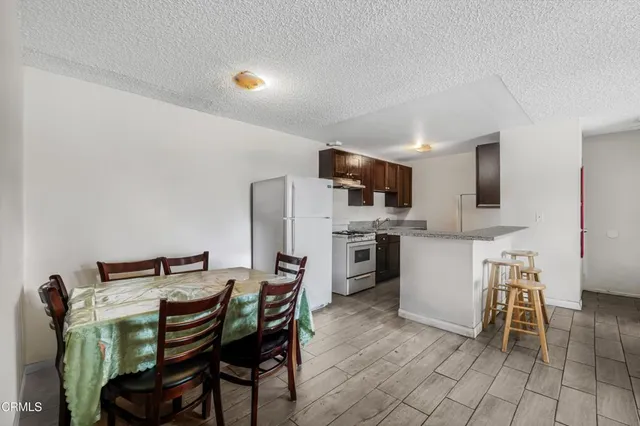 a view of kitchen with sink and chairs