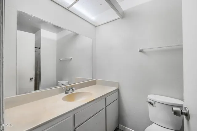 a bathroom with a sink toilet and a mirror