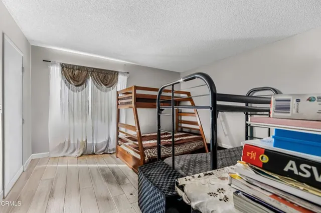 a bedroom with bunk bed and a dresser