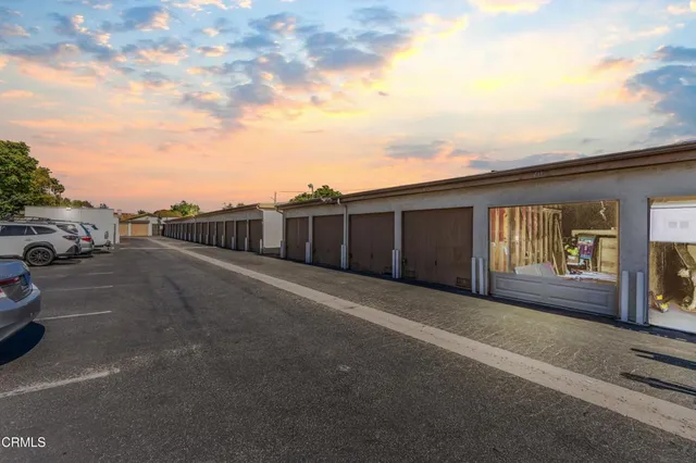 a view of a street with car parked