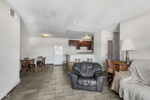 a living room with furniture and a dining area with fireplace