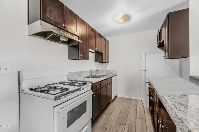 a kitchen with stainless steel appliances granite countertop a stove and a sink