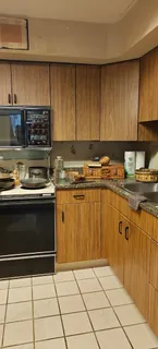 a kitchen with a refrigerator and a stove