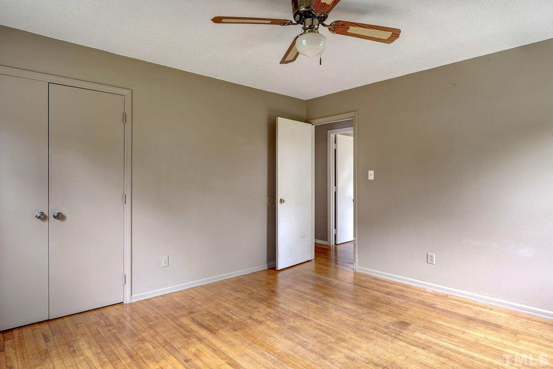 5816 Neuse Street Raleigh, NC 27610 - Photo 16 of 32 a view of a room with a wooden floor and a ceiling fan