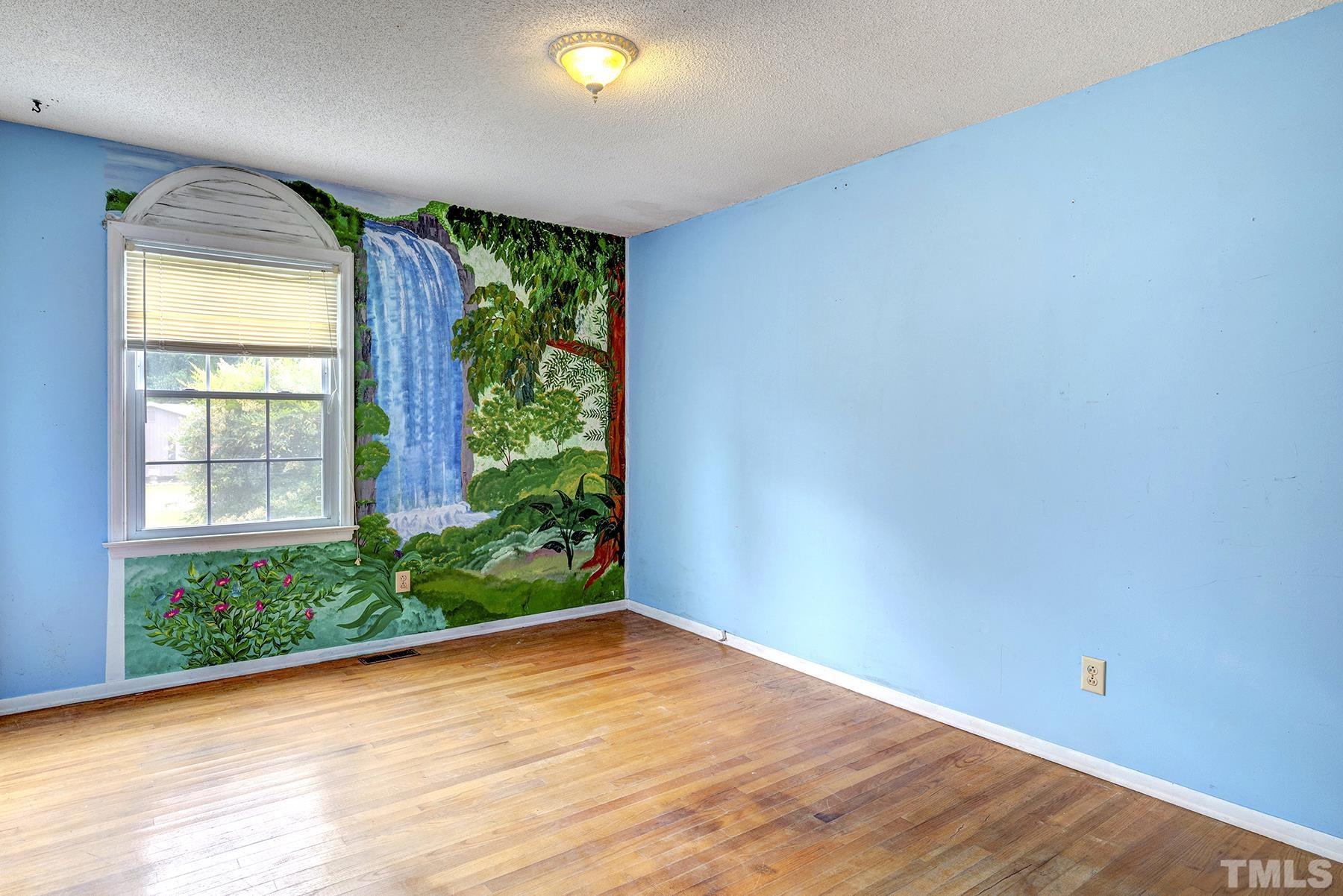 5816 Neuse Street Raleigh, NC 27610 - Photo 19 of 32 an empty room with wooden floor and windows