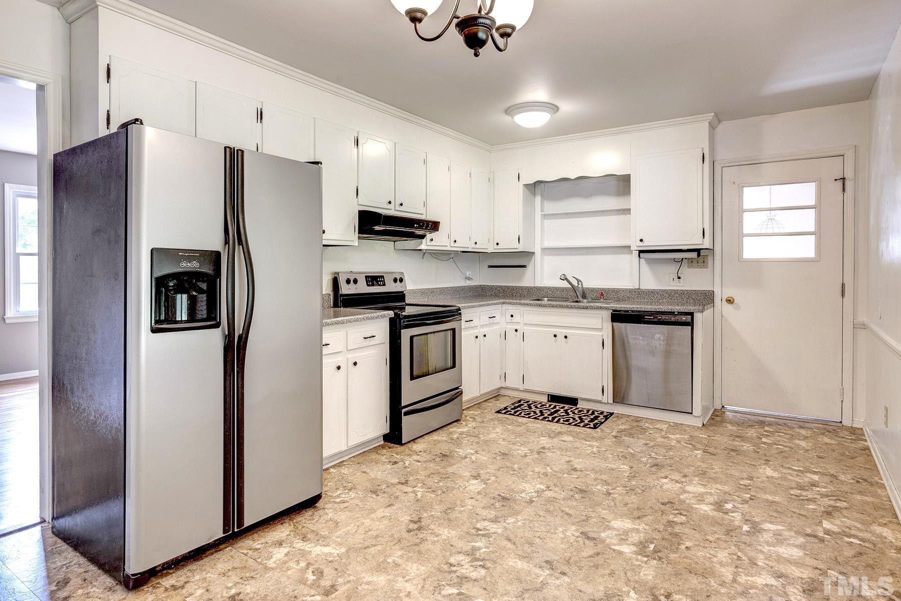 5816 Neuse Street Raleigh, NC 27610 - Photo 3 of 32 a kitchen with stainless steel appliances a refrigerator sink and cabinets